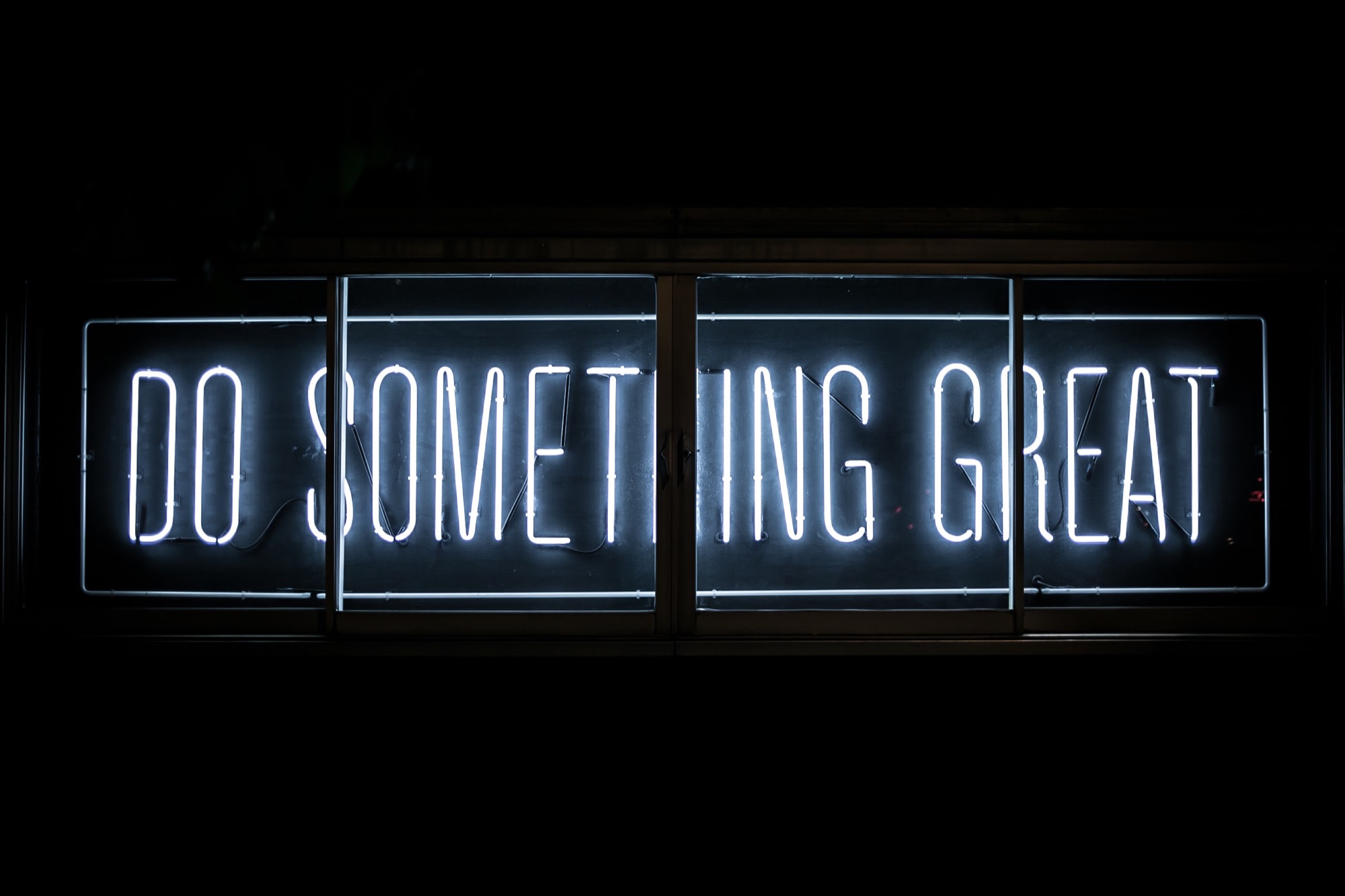 A neon sign reading Do Something Great